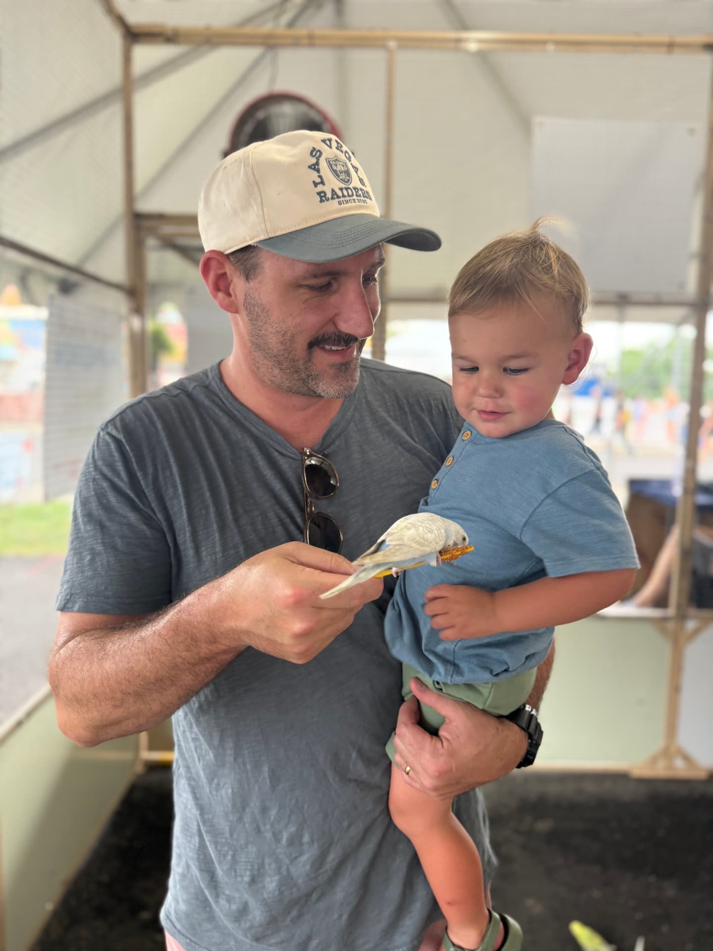 Jay Harmas holding his youngest at the state fair