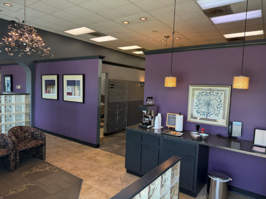 The lobby at Blades Hair Design, with a chandelier, coffee bar and glass-block partition