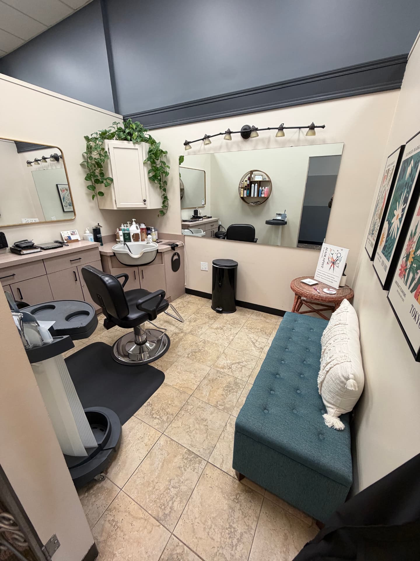 A private studio at Blades Hair Design with a styling chair, shampoo bowl and seating bench